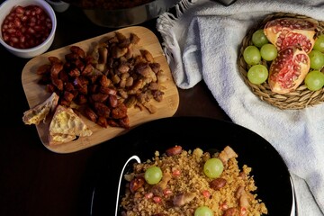 Food spanish crumbs with sausages, bacon, pomegranate and grapes