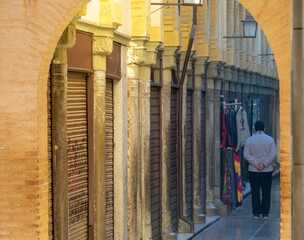 Famous Arab bazaar in Granada without tourists due to the pandemic with a lonely vendor on his back