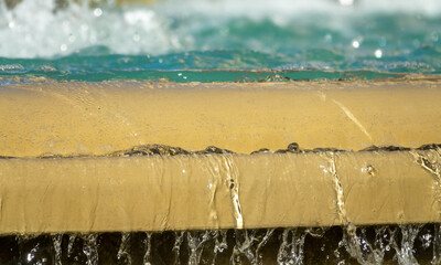 Detail of water falling over the edge of a fountain