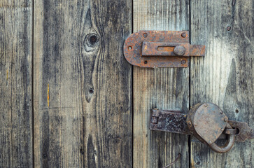 Old wooden door locked on padlock