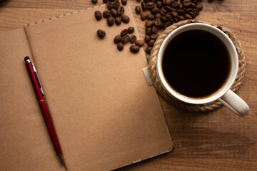 Coffee Background, brown coffee concept photo, Coffee and notepad on wooden table, copy space for your text. selective focus.
