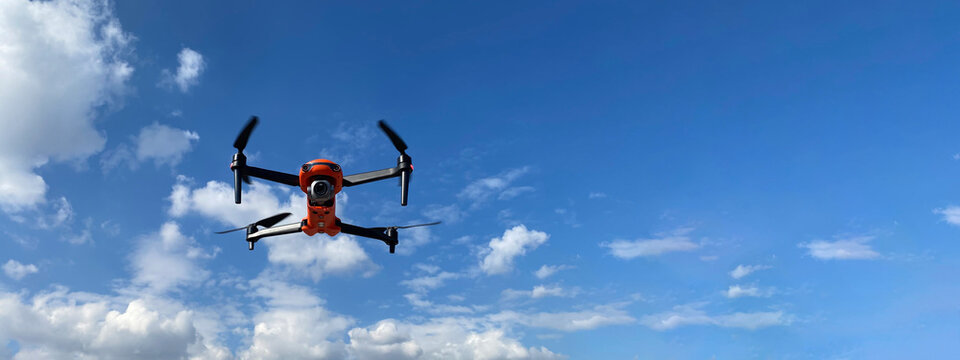 Ultra wide panoramic zoom photo of latest technology RC camera drone or UAV (unmanned aerial vehicle) on a cloudy deep blue sky