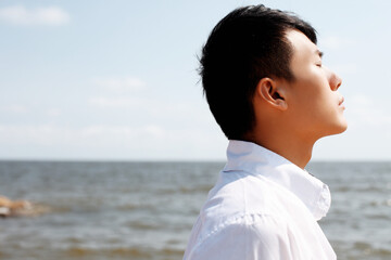 Portrait of Young man standing on seaside