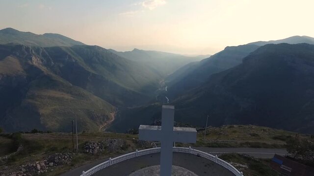 Aerial footage of a large white cross that looks out over the valley.