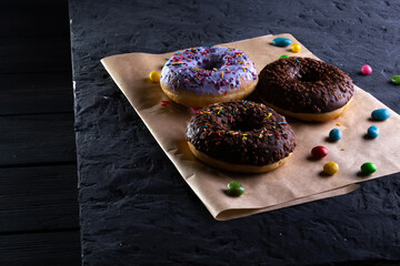 Donuts on a wooden board on a blue concrete background