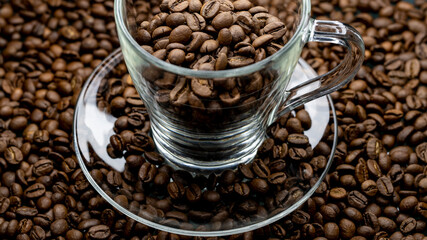 
a cup of coffee among roasted coffee beans