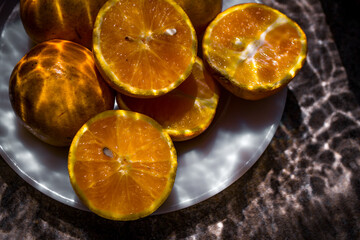 photography of oranges with water reflection