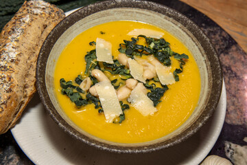 A delicious bowl of Kale Bean and Winter Root Soup in a bowl in a kitchen