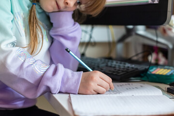 Young girl working at home during lockdown as children need to home school via online learning