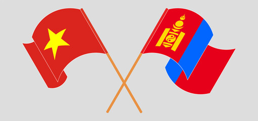 Crossed and waving flags of Vietnam and Mongolia