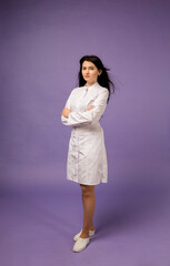 a woman doctor in a full-length medical gown stands on a purple background
