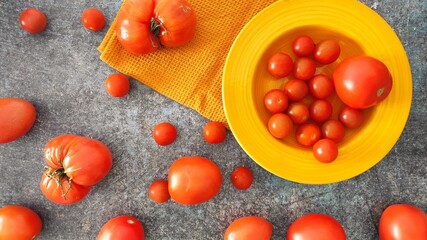 A yellow bowl od red tomatoes 
