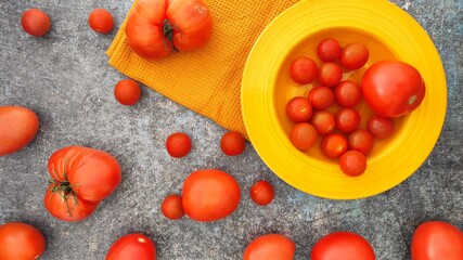 A yellow bowl od red tomatoes 
