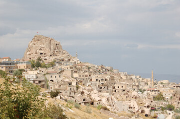 Fototapeta na wymiar Ancient troglodyte village of Uchisar, in Cappadocia (Central Anatolia, Turkey). Fairy chimneys 