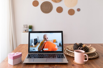 Fototapeta premium Man connecting online with laptop is romantically showing his love with a red heart balloon in his hand. new normally living remote love.