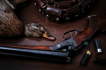 Hunting still life with wild duck, bandolier and Sauer smoothbore hunting rifle