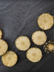 Obraz na płótnie Canvas Chopped pineapples on a silver table