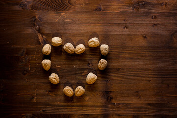 noci disposte in forma di  cuore su tavolo in legno