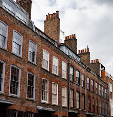 Fototapeta premium Row of typical London houses with brick wall