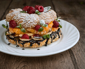 sweet bagel sandwich with bananas, tangerines and raspberries