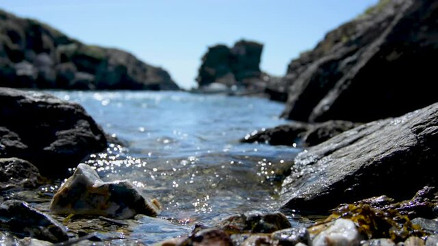 Water lapping on the shore in a french iland