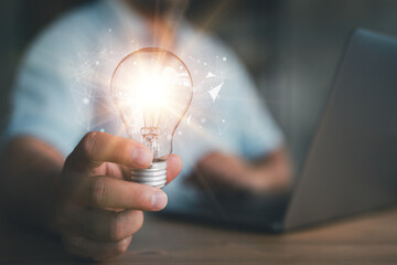 Innovation. Hands holding light bulb for Concept new idea concept with innovation and inspiration,...
