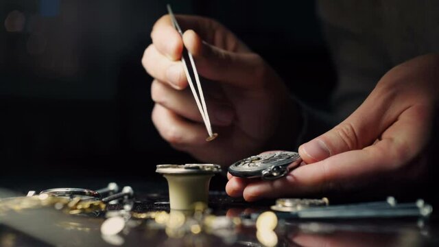 Mechanical watch repair process. Open pocket wristwatch. Watchmaker adjust watch. Precise occupation. High accuray level
