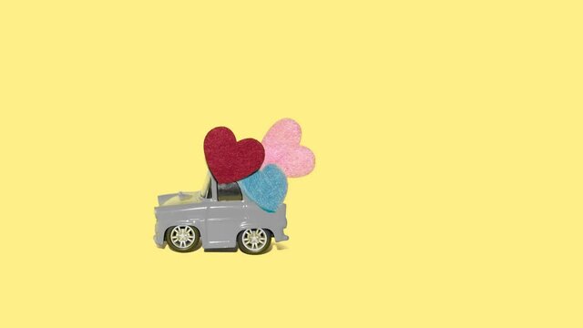 Valentine's day celebration with retro toy car and hearts, pantone colors 2021
