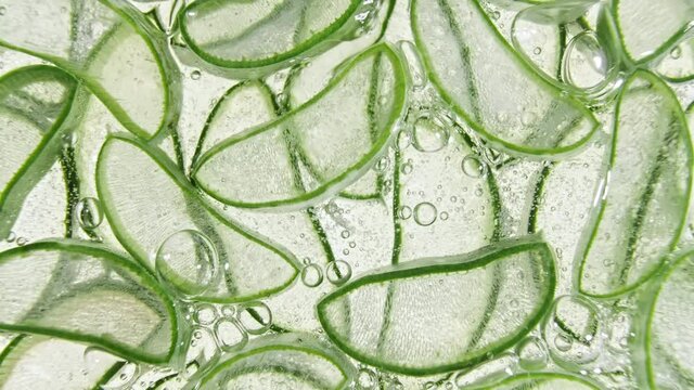 Closeup Aloe Vera sliced slice. Motion of the juice aloe vera. Natural medical plant. Organic cosmetics, alternative medicine. Top view. High quality 4k footage