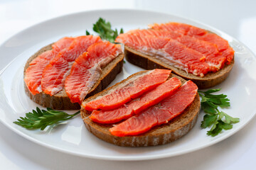 Sandwiches with red salted fish and greens