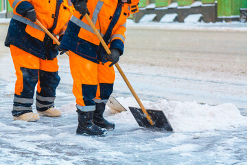 Communal services workers sweep snow from road in winter, Cleaning city streets and roads during snowstorm. Moscow, Russia.