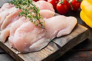 Raw chicken meat, on old dark  wooden table background