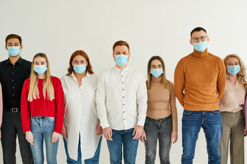 careful crowd of people of caucasian ethnicity using face facial sterile masks isolated over white studio background. stop coronavirus COVID-19 spreading