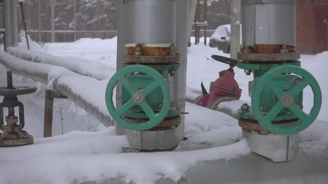 Pipes and valves on heavy snow in winter.