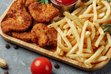 plate with snacks. breaded chicken nuggets, fried potatoes and jamon