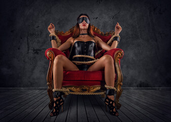 Sexy woman in lingerie and bdsm style in old armchair - obrazy, fototapety, plakaty