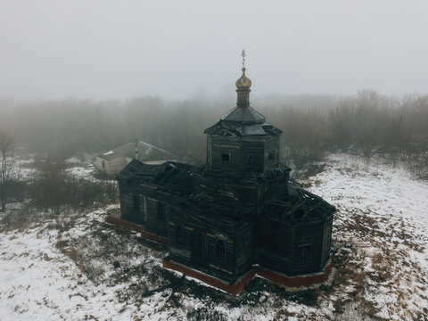 Old abandoned wooden ruined Russian church of Athanasius the Great in Lower Babino, Kursk region, aerial view