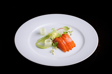 Raw salmon served with red radish and dressing sauce