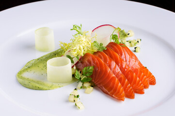 Raw salmon served with red radish and dressing sauce