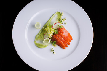 Raw salmon served with red radish and dressing sauce