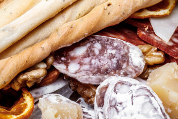 Traditional sausage, moldy. Sliced salami sausage sausage, orange, cheese . Close-up. Horizontal photo.