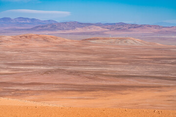 Atacama Desert arid landscape view. Dry mountains with sandstone and no life around us just rocks and sand. A lonely feeling on this amazing and wild scenery at a remote place