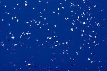 Fototapeta na wymiar Beautiful festive blue background with metallic shaped confetti. Holiday decoration concept.