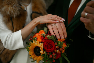 Obraz na płótnie Canvas Hands of the bride and groom with rings.