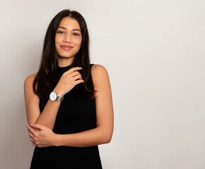 Fototapeta premium Beautiful young woman with long black hair wearing wirst watch, Youthful and radian girl with natural make-up