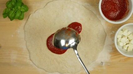 spread the tomato sauce on the pizza video