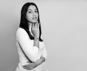 Beautiful young woman with long black hair wearing wirst watch, Youthful and radian girl with natural make-up