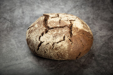 Rye bread with a crisp crust on a gray mottled background