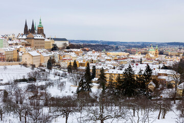 Snowy Prague City with gothic Castle from Hill Petrin in the sunny Day, Czech republic