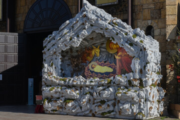Nativity scene in the front from the church, creche, or crib, is a depiction of the birth of Jesus